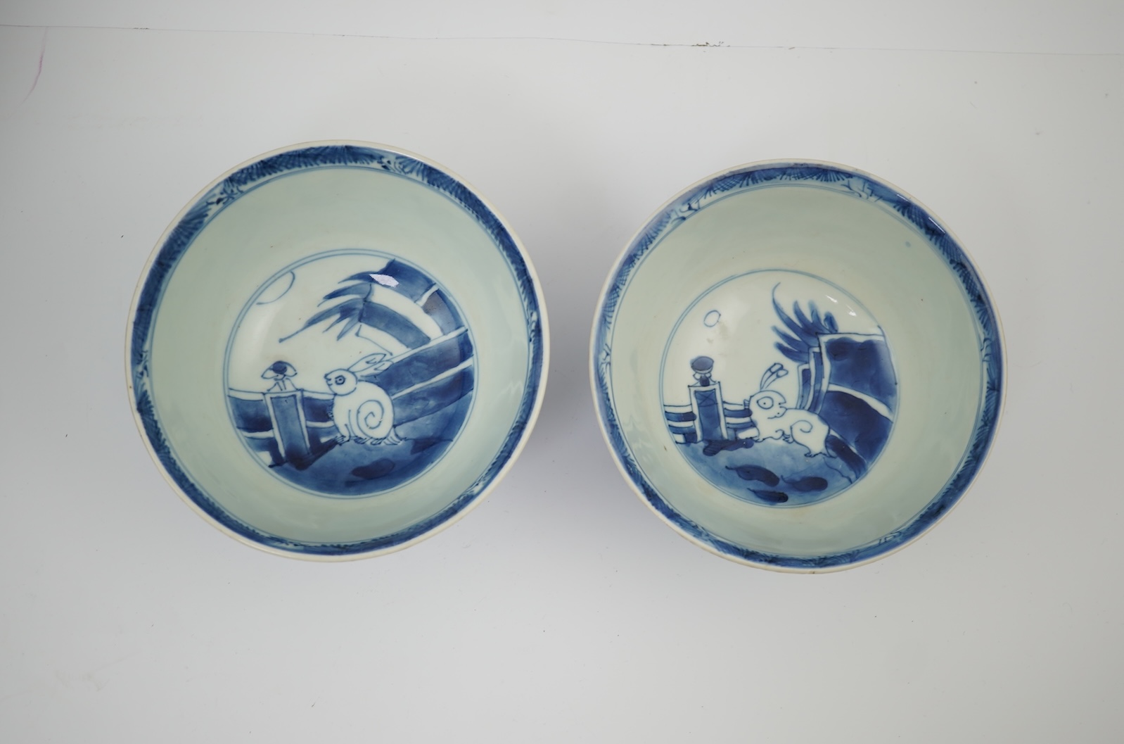 A pair of Chinese Transitional blue and white 'mythical beasts' bowls, early Kangxi period